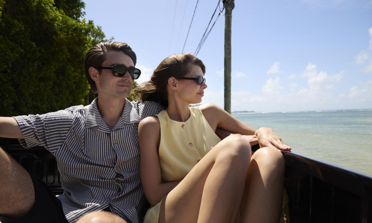 Couple at the back of a pickup sightseeing
