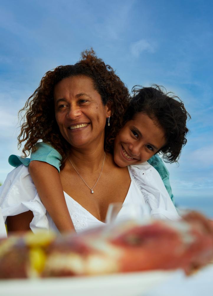 Mother and daughter smiling at the camera